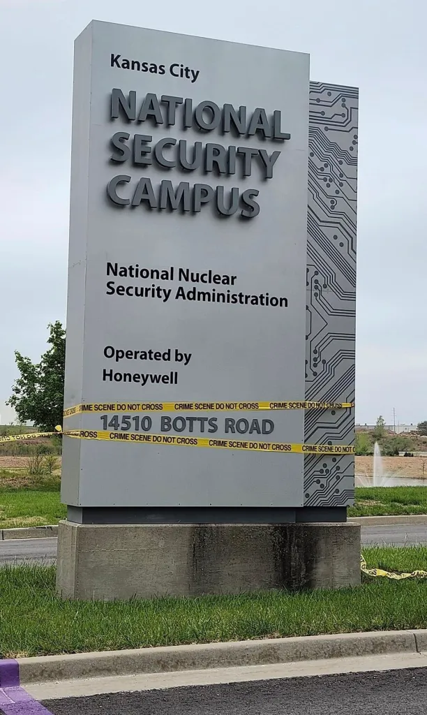 kc nsc signage with crime scene tape wrapped around it, because nuclear weapons are internationally illegal